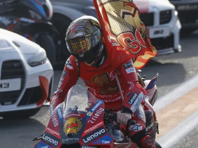 Moto GP World Champion Italian rider Francesco Bagnaia of the Ducati Lenovo Team celebrates after the MotoGP race of the Valencia Motorcycle Grand Prix, the last race of the season, at the Ricardo Tormo circuit in Cheste near Valencia, Spain, Sunday, Nov. 26, 2023. (AP Photo/Alberto Saiz)