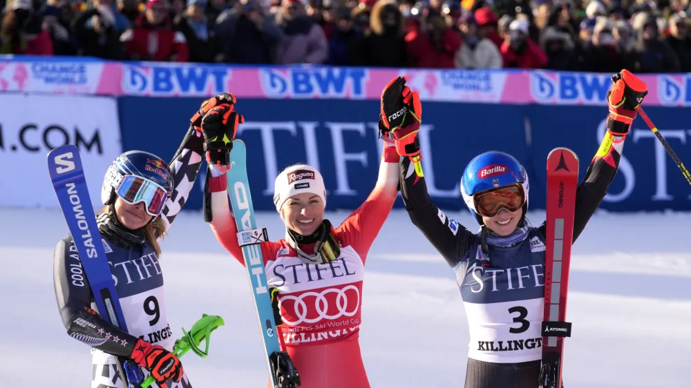 Winner Lara Gut-Behrami of Switzerland, center, celebrates with second place finisher Alice Robinson of New Zealand, left and third place Mikaela Shiffrin of United States, right, after a women's World Cup giant slalom skiing race Saturday, Nov. 25, 2023, in Killington, Vt. (AP Photo/Robert F. Bukaty)