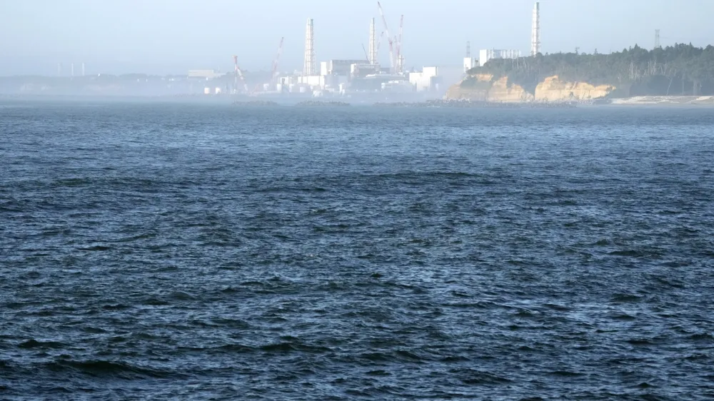 FILE - The Fukushima Daiichi nuclear power plant, damaged by a massive March 11, 2011, earthquake and tsunami, is seen from the nearby Ukedo fishing port in Namie town, northeastern Japan, on Aug. 24, 2023. The release of a third batch of treated radioactive wastewater from Japan's damaged Fukushima nuclear plant into the Pacific Ocean ended safely as planned, its operator said Monday, Nov. 20, as the country's seafood producers continue to suffer from a Chinese import ban imposed after the discharges began. (AP Photo/Eugene Hoshiko, File)