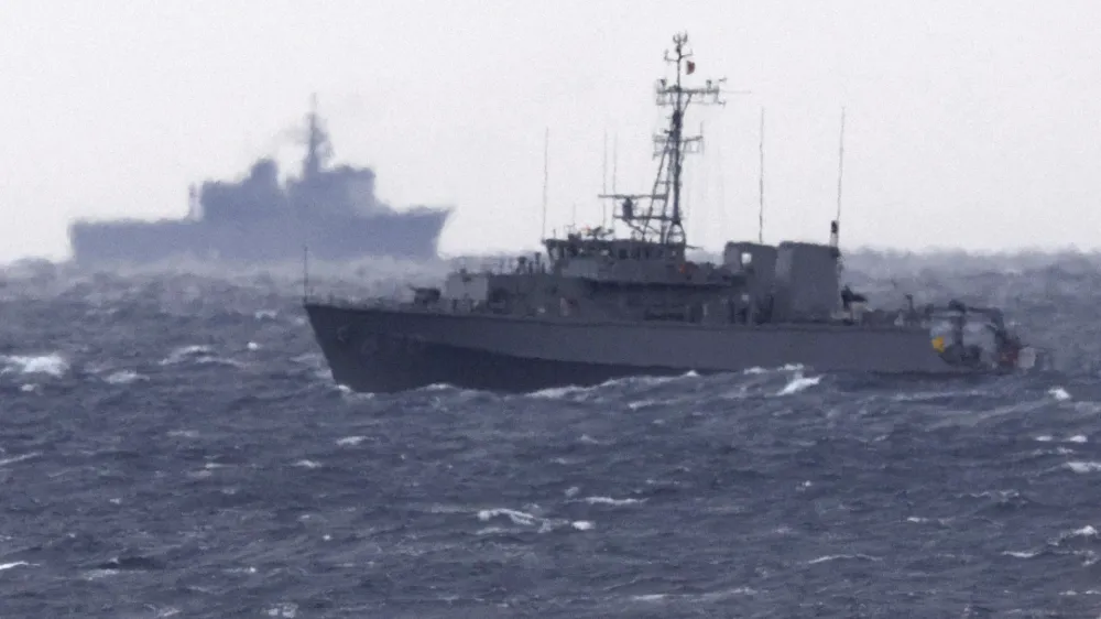 A Japanese Maritime Self Defense Force minesweeper searches in the waters where a U.S. military Osprey aircraft crashed, off Yakushima, Kagoshima prefecture, southern Japan, Friday, Dec. 1, 2023. Japan suspended flights by its Osprey aircraft Thursday, officials said, the day after the U.S. Air Force Osprey based in Japan crashed into the sea during a training mission. (Kyodo News via AP)