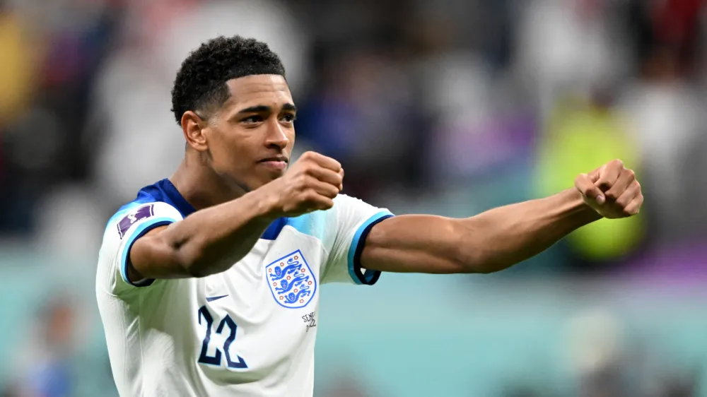 FILED - 04 December 2022, Qatar, Al-Chaur: England's Jude Bellingham celebrates after the FIFA World Cup Qatar 2022 round of 16 soccer match between England and Senegal at Al-Bait Stadium. Bellingham has revealed his ambitions to win all trophies with England national team and Real Madrid. Photo: Robert Michael/dpa