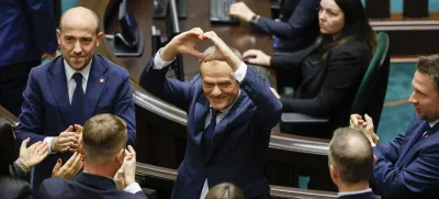 Donald Tusk shows a heart with his hands to lawmakers after he was elected as Poland's Prime Minister at the parliament in Warsaw, Poland, Monday Dec. 11, 2023. (AP Photo/Michal Dyjuk)