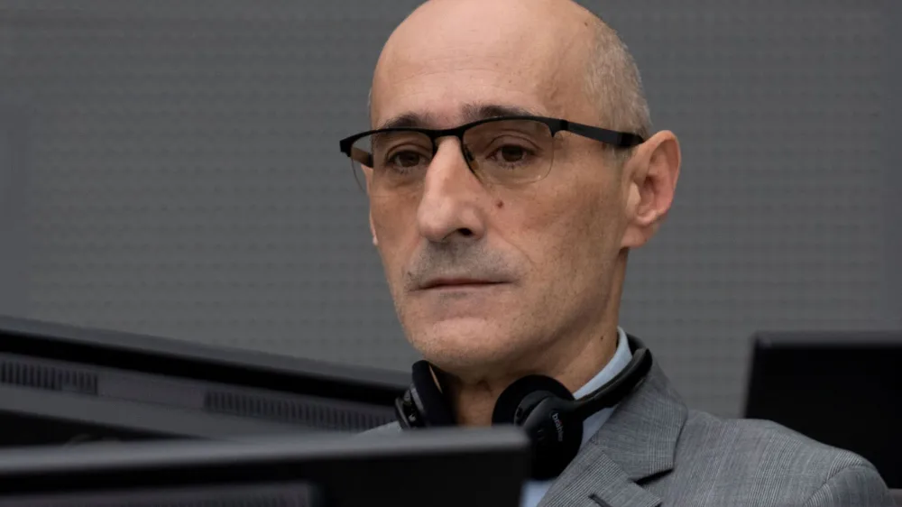 Salih Mustafa, a former Kosovo rebel, waits in the Kosovo Specialist Chambers court for the judges to read the verdict in The Hague, Netherlands, December 16, 2022. Mustafa is charged with the war crimes of arbitrary detention, cruel treatment, the torture of at least six people and the murder of one person at a detention compound in Zllash, Kosovo, in April 1999. Salih Mustafa pleaded not guilty to all charges. Peter Dejong/Pool via REUTERS