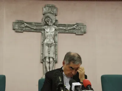 FILE - Cardinal Angelo Becciu talks to journalists during a press conference in Rome, Friday, Sept. 25, 2020. Lawyers for the once-powerful cardinal have accused Vatican prosecutors of being "prisoners to their completely shattered theory" in closing arguments of a two-year trial. Becciu is on trial along with nine other people in a case that is focused on the Vatican's 350 million-euro investment in a London property. (AP Photo/Gregorio Borgia)