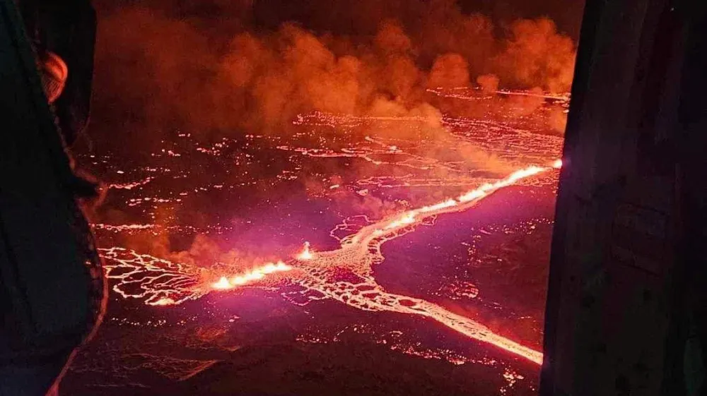 A volcano spews lava and smoke as it erupts near Grindavik, Iceland, December 19, 2023. Civil Protection of Iceland/Handout via REUTERS THIS IMAGE HAS BEEN SUPPLIED BY A THIRD PARTY. NO RESALES. NO ARCHIVES. MANDATORY CREDIT