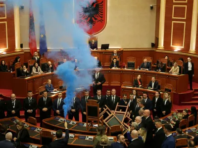 A member of parliament from the Democratic Party, Albania's biggest opposition party, sets off a smoke flare as the parliament gathers for a vote on whether to lift the immunity of opposition leader Sali Berisha so he can face corruption charges, in Tirana, Albania, December 21, 2023 REUTERS/Florion Goga   TPX IMAGES OF THE DAY