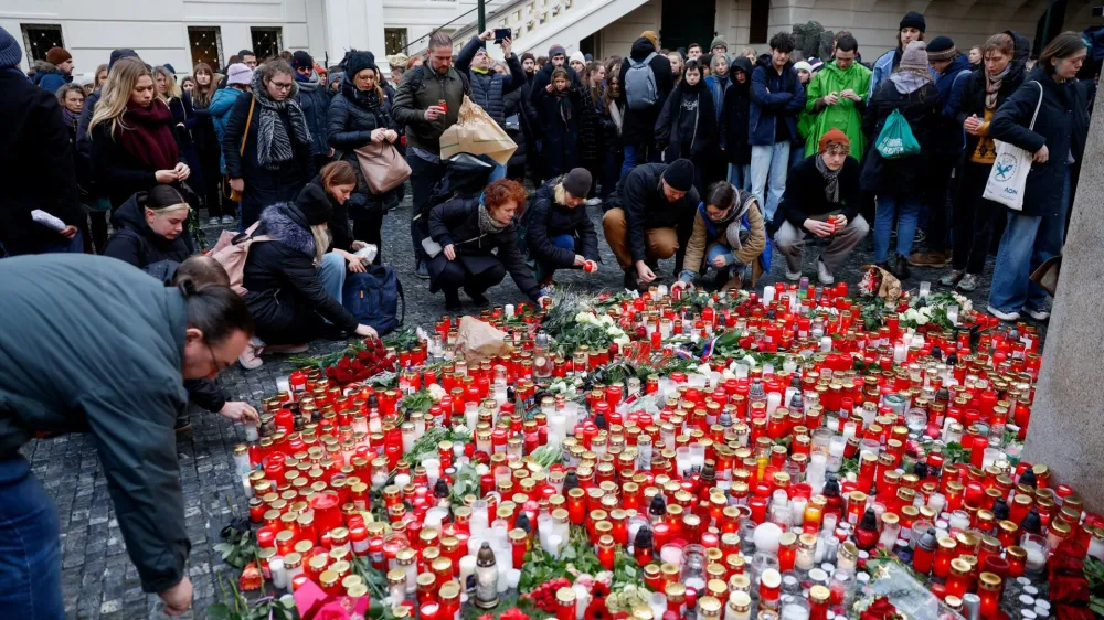 People lay tributes at a memorial during a vigil following a shooting at one of Charles University's buildings in Prague, Czech Republic, December 22, 2023. REUTERS/David W Cerny