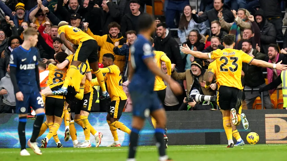 24 December 2023, United Kingdom, Wolverhampton: Wolverhampton Wanderers' Matt Doherty (hidden) celebrates scoring his side's second goal of the game with team-mates during the English Premier League soccer match between Wolverhampton and Chelsea at Molineux Stadium. Photo: Jacob King/PA Wire/dpa