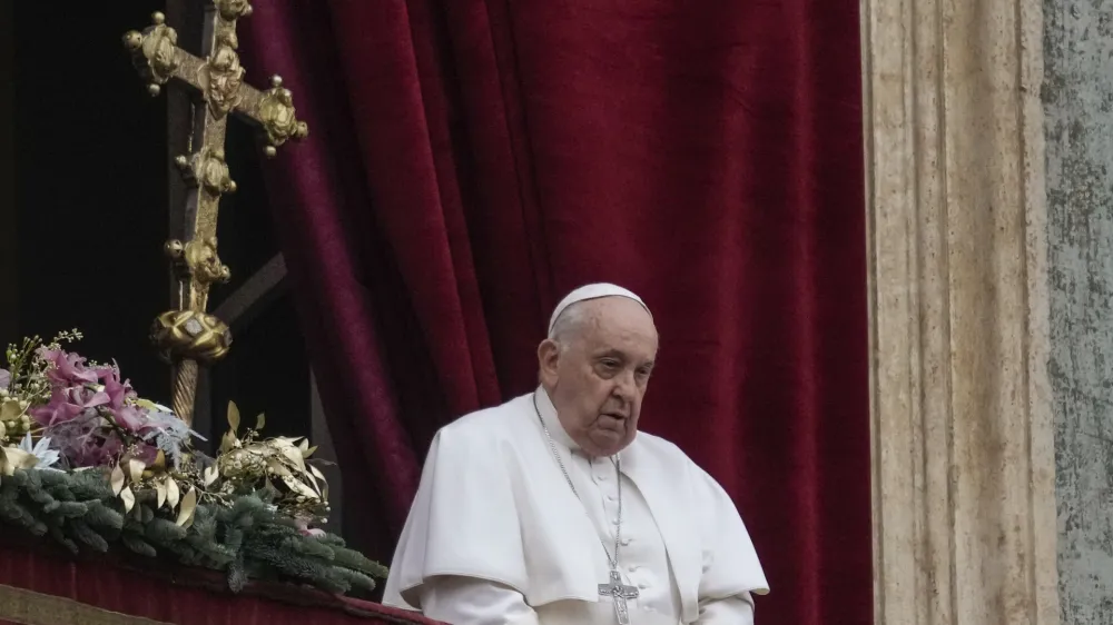 Pope Francis stands before delivering the Urbi et Orbi (Latin for 'to the city and to the world') Christmas' day blessing from the main balcony of St. Peter's Basilica at the Vatican, Monday Dec. 25, 2023. (AP Photo/Gregorio Borgia)