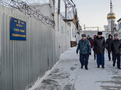 In this photo released by Human rights ombudsman of Yamalo-Nenets Autonomous District on Friday, Dec. 15, 2023, a group of officers walk inside a prison colony in the town of Kharp, in the Yamalo-Nenetsk region about 1,900 kilometers (1,200 miles) northeast of Moscow. Associates of imprisoned Russian opposition leader Alexei Navalny say he has been located at a prison colony above the Arctic Circle nearly three weeks after contact with him was lost. (Human rights ombudsman of Yamalo-Nenets Autonomous District via AP)
