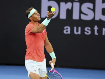 Rafael Nadal of Spain serves in his doubles match against Australia's Max Purcell and Jordan Thompson during the Brisbane International tennis tournament in Brisbane, Australia, Sunday, Dec. 31, 2023. (AP Photo/Tertius Pickard)