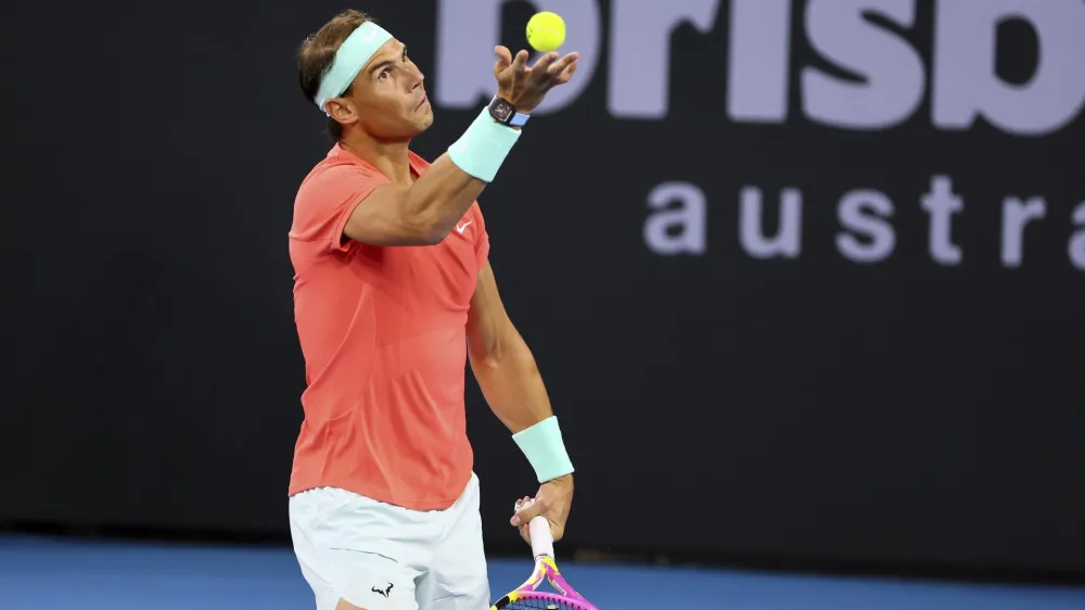 Rafael Nadal of Spain serves in his doubles match against Australia's Max Purcell and Jordan Thompson during the Brisbane International tennis tournament in Brisbane, Australia, Sunday, Dec. 31, 2023. (AP Photo/Tertius Pickard)