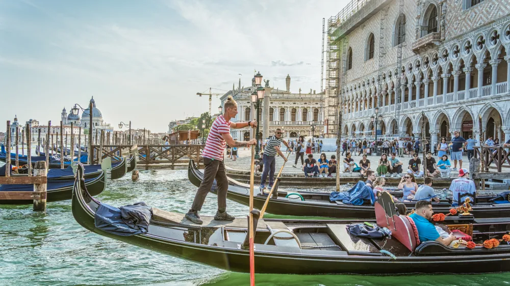 Venice, Italy - May 29 2023: Traditional gondola ride on the Grand Canal.Tourists in Venice.