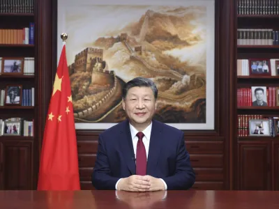 In this photo released on Sunday, Dec. 31, 2023 by Xinhua News Agency, Chinese President Xi Jinping delivers a New Year message in Beijing to ring in 2024. (Ju Peng/Xinhua via AP)