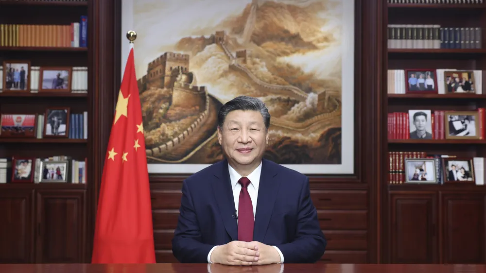 In this photo released on Sunday, Dec. 31, 2023 by Xinhua News Agency, Chinese President Xi Jinping delivers a New Year message in Beijing to ring in 2024. (Ju Peng/Xinhua via AP)