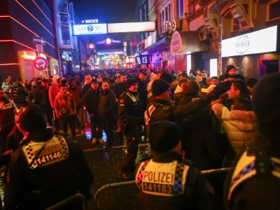 01 January 2024, Hamburg: Police forces block access to the Grosse Freiheit on the Reeperbahn shortly after the turn of the year. Photo: Christian Charisius/dpa