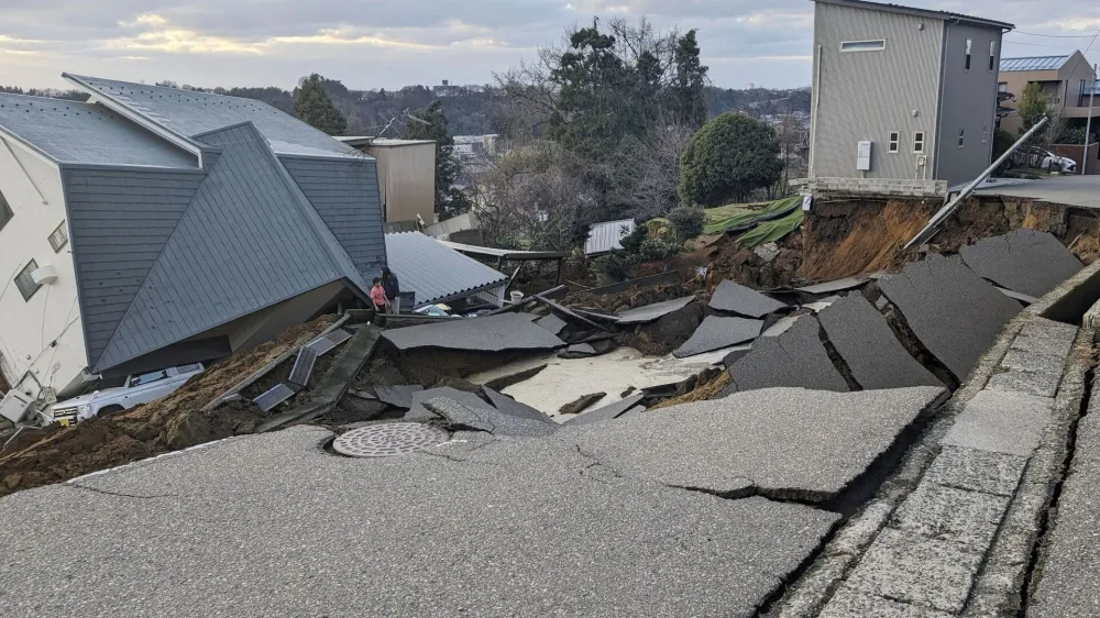 A view of a collapsed road and houses because of an earthquake in Wajima, Ishikawa prefecture, Japan January 2, 2024, in this photo released by Kyodo. Mandatory credit Kyodo via REUTERS ATTENTION EDITORS - THIS IMAGE WAS PROVIDED BY A THIRD PARTY. MANDATORY CREDIT. JAPAN OUT. NO COMMERCIAL OR EDITORIAL SALES IN JAPAN