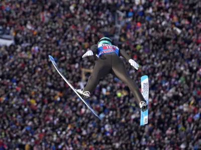 Lovro Kos, of Slovenia, soars through the air during his first round jump at the second stage of the 72th Four Hills ski jumping tournament in Garmisch-Partenkirchen, Germany, Monday, Jan. 1, 2024. (AP Photo/Matthias Schrader)