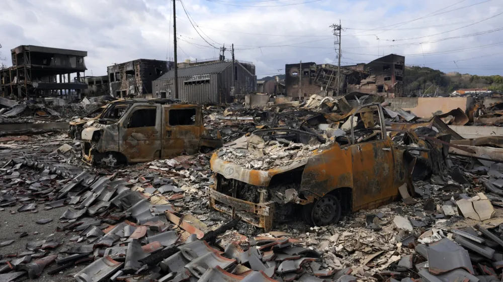 Burned-out vehicles are seen after a fire at a shopping area in Wajima in the Noto peninsula, facing the Sea of Japan, northwest of Tokyo, Friday, Jan. 5, 2024, following Monday's deadly earthquake. (AP Photo/Hiro Komae)