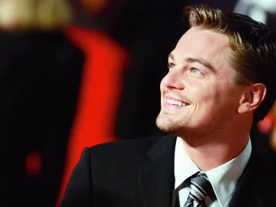 ** ALTERNATIVE CROP ** Actor Leonardo Di Caprio smiles as he arrives at Rome's Auditorium, Sunday, Oct. 15, 2006, to present the movie "The departed", at the first ever edition of the Rome "Festa del Cinema" Film Festival. (AP Photo/Andrew Medichini)na 28cc