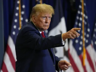 Former President Donald Trump leaves the stage during a commit to caucus rally, Friday, Jan. 5, 2024, in Mason City, Iowa. (AP Photo/Charlie Neibergall)