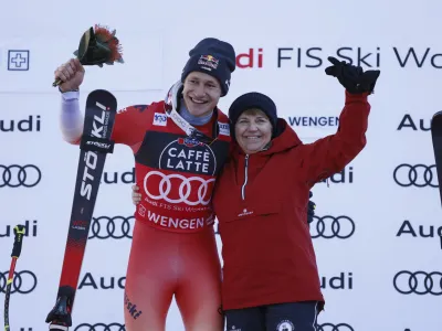 Switzerland's Marco Odermatt and Swiss Federal president Viola Amherd, celebrate after an alpine ski, men's World Cup downhill race, in Wengen, Switzerland, Saturday, Jan. 13, 2024. (AP Photo/Alessandro Trovati)
