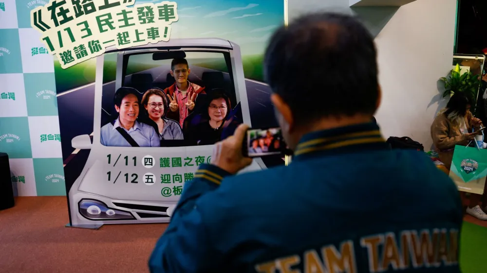A supporter of the Democratic Progressive Party (DPP) poses for a picture during a rally, following the victory of Lai Ching-te in the presidential elections, in Taipei, Taiwan January 13, 2024. REUTERS/Ann Wang