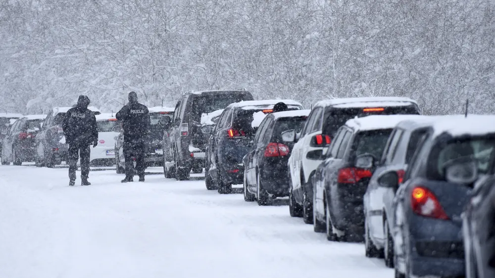 Motorists blocked by snow wait to continue their journeys, near Gospic, Croatia, Monday, Feb. 27, 2023. Hundreds of people in Croatia have spent the night in their cars or in cafes and reception centers after a snow storm on weekend caused a traffic collapse and left parts of the country cut off. (AP Photo)