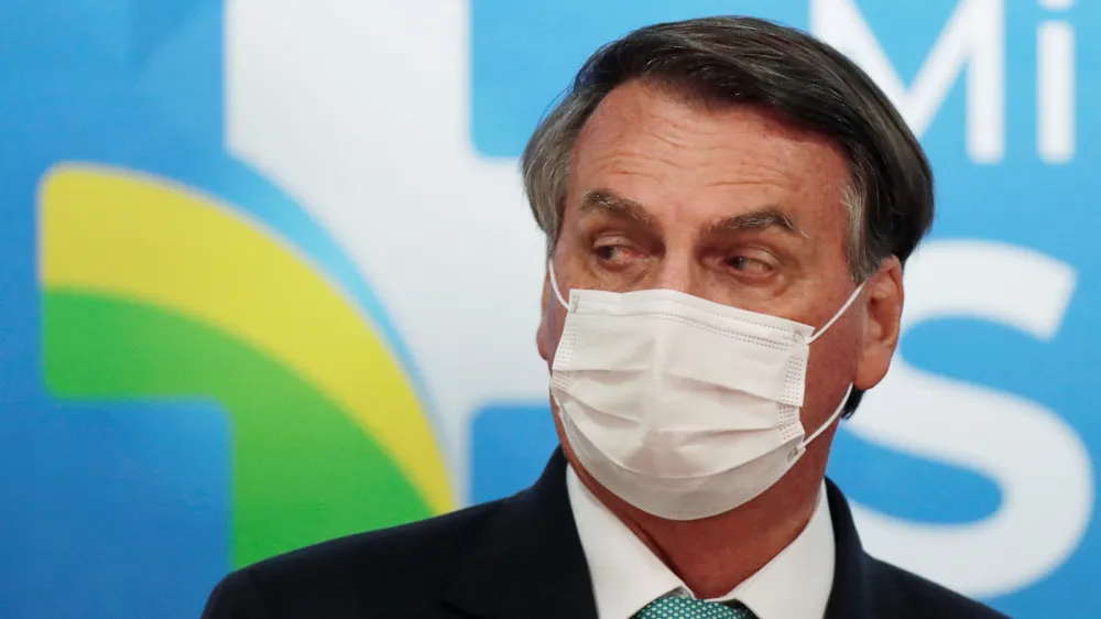 FILE PHOTO: Brazil's President Jair Bolsonaro looks on during a ceremony of signing the Vaccine Technology Transfer Agreement for Oxford/AstraZeneca coronavirus disease (COVID-19) vaccines, in Brasilia, Brazil, June 1, 2021. REUTERS/Ueslei Marcelino/File Photo