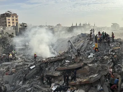 FILE - Palestinians look for survivors following Israeli airstrike in Nusseirat refugee camp, Gaza Strip, Tuesday, Oct. 31, 2023. Israel's war on Hamas in the Gaza Strip has the Mideast simmering, raising the temperature on tensions across the region and increasing the risk that seemingly localized conflicts could spin out of control. (AP Photo/Doaa AlBaz, File)