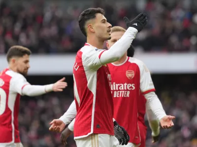 Arsenal's Gabriel Martinelli, centre, celebrates with teammates after scoring his side's fifth goal during the English Premier League soccer match between Arsenal and Crystal Palace at Emirates Stadium in London, Saturday, Jan. 20, 2024. (AP Photo/Kirsty Wigglesworth)