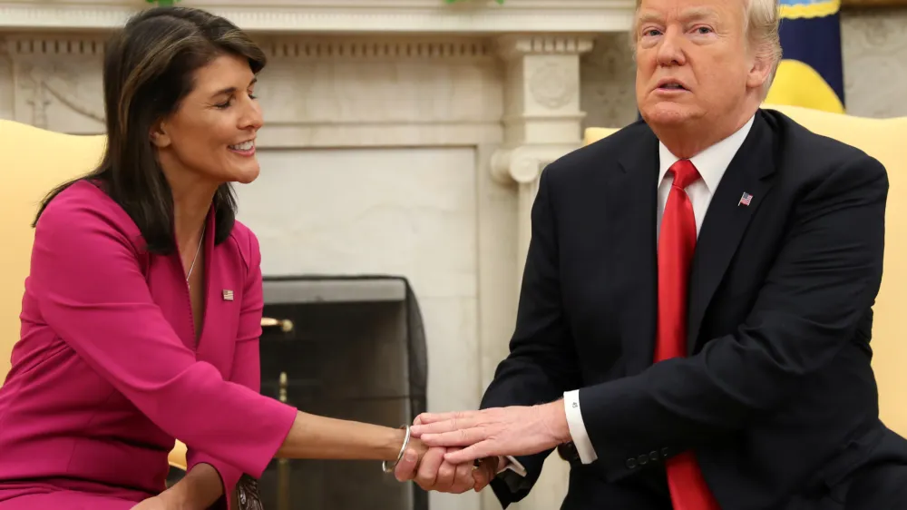 U.S. President Donald Trump greets U.N. Ambassador Nikki Haley in the Oval Office of the White House as the president accepted the Haley's resignation in Washington, U.S., October 9, 2018. REUTERS/Jonathan Ernst