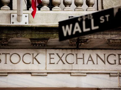 FILE PHOTO: A street sign for Wall Street hangs in front of the New York Stock Exchange May 8, 2013. REUTERS/Lucas Jackso//File Photo