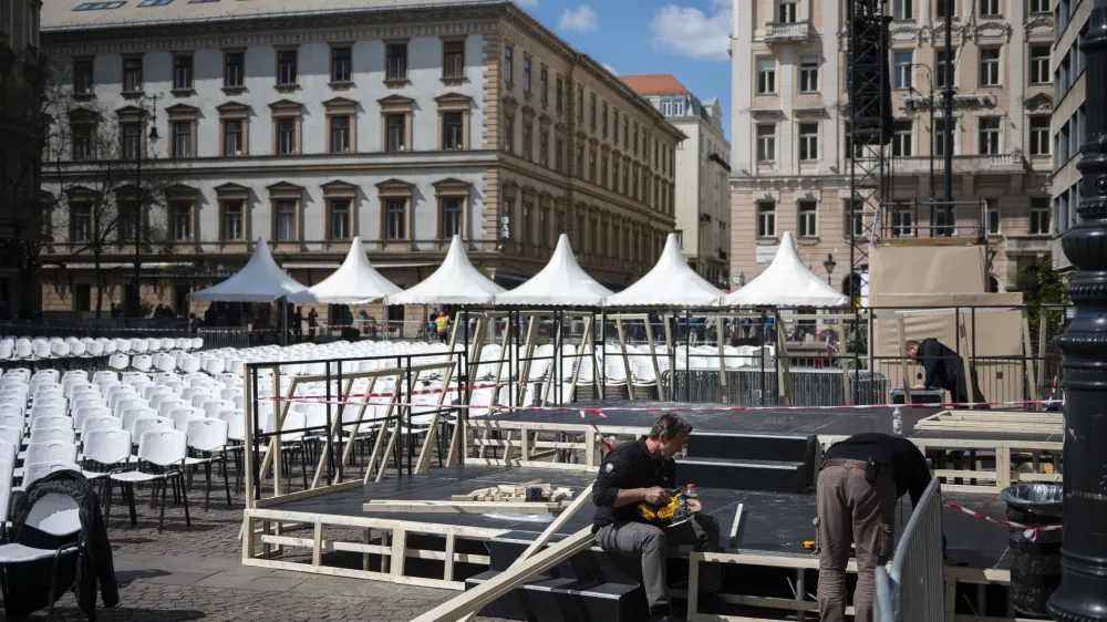Workers set the stage in front of St. Stephen's Basilica in Budapest on Thursday, April 27, 2023 where Pope Francis will meet with bishops, priests and pastoral workers during his visit to Hungary. The spiritual priorities of Pope Francis will be on display during a trip this week to Hungary, where the populist government will seek to downplay its diverging views on matters like immigration and minority rights while focusing instead on points where it aligns with the pontiff. (AP Photo/Denes Erdos)
