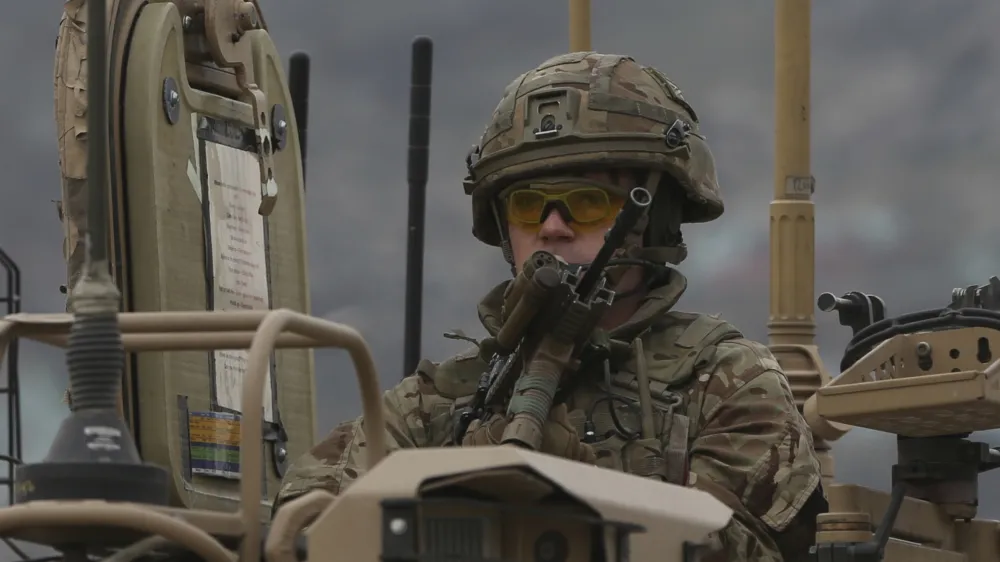 FILE - A British soldier with NATO-led Resolute Support Mission forces arrives at the site of an attack in Kabul, Afghanistan, Wednesday, March 25, 2020. The U.K. government said Wednesday it has no plans to introduce conscription, after the head of the British Army said a "citizen army" would be needed to fight a future war with a country like Russia. (AP Photo/Rahmat Gul, File)