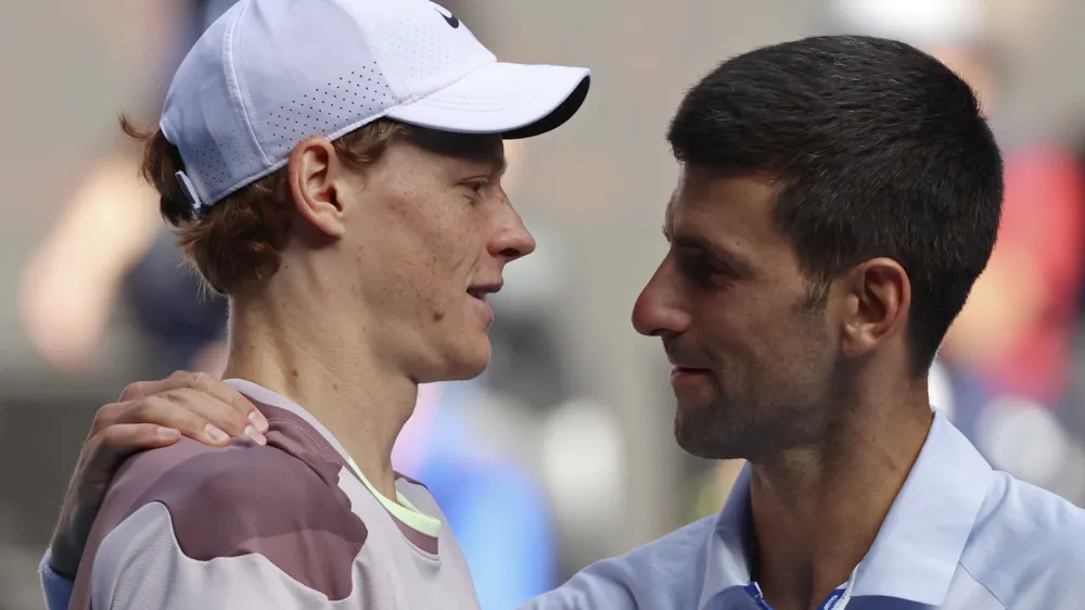 Jannik Sinner, left, of Italy is congratulated by Novak Djokovic of Serbia following their semifinal at the Australian Open tennis championships at Melbourne Park, Melbourne, Australia, Friday, Jan. 26, 2024. (AP Photo/Asanka Brendon Ratnayake)