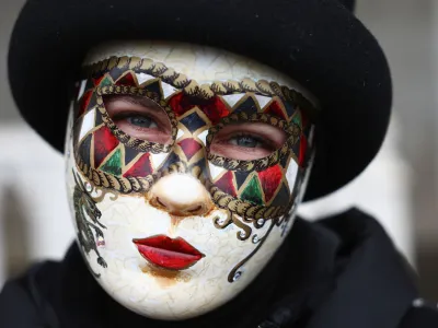 A masked reveller takes part in the Venice carnival in St. Mark's Square in Venice, Italy, January 27, 2024. REUTERS/Guglielmo Mangiapane