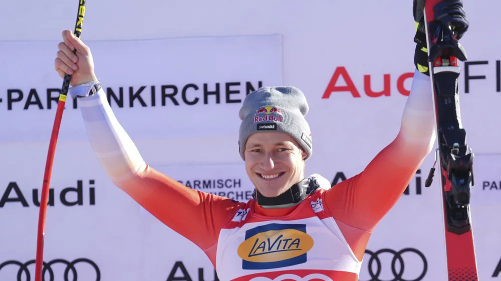 The winner Switzerland's Marco Odermatt celebrates after an alpine ski, men's World Cup super G race, in Garmisch-Partenkirchen, Germany, Sunday, Jan. 28, 2024. (AP Photo/Giovanni Auletta)