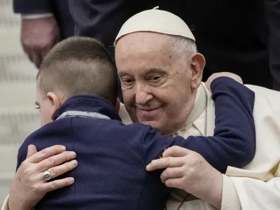 Pope Francis embraces a young boy during his weekly general audience in the Pope Paul VI hall at the Vatican, Wednesday, Jan. 31, 2024. (AP Photo/Andrew Medichini)