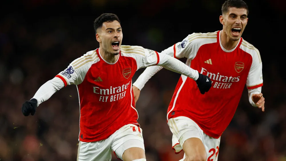 Soccer Football - Premier League - Arsenal v Liverpool - Emirates Stadium, London, Britain - February 4, 2024 Arsenal's Gabriel Martinelli celebrates scoring their second goal with Kai Havertz Action Images via Reuters/John Sibley NO USE WITH UNAUTHORIZED AUDIO, VIDEO, DATA, FIXTURE LISTS, CLUB/LEAGUE LOGOS OR 'LIVE' SERVICES. ONLINE IN-MATCH USE LIMITED TO 45 IMAGES, NO VIDEO EMULATION. NO USE IN BETTING, GAMES OR SINGLE CLUB/LEAGUE/PLAYER PUBLICATIONS.   TPX IMAGES OF THE DAY