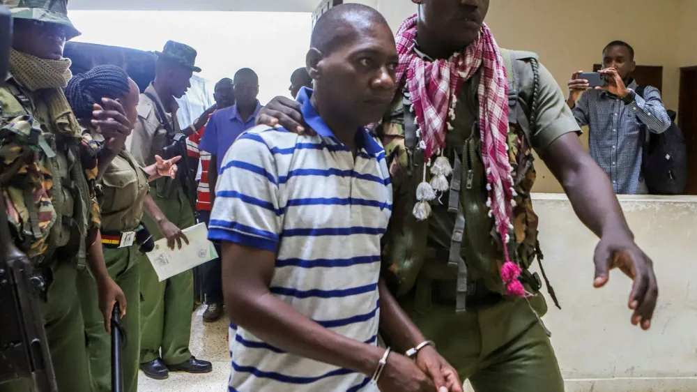 FILE PHOTO: Paul Mackenzie, a Kenyan cult leader accused of ordering his followers, who were members of the Good News International Church, to starve themselves to death in Shakahola forest, is escorted to the Malindi Law Courts in Malindi, Kilifi, Kenya January 17, 2024. REUTERS/Stringer/File Photo