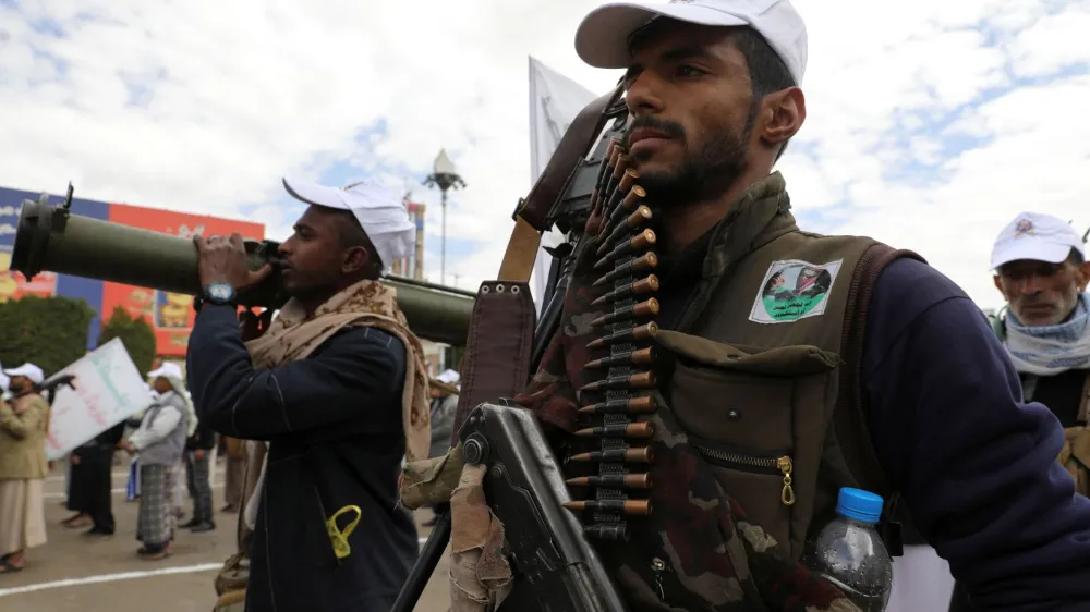A Houthi follower holds a machine gun with ammunition belt during a parade in a show of force amid a standoff in the Red Sea and U.S.-led airstrikes on Houthi targets, in Sanaa, Yemen, February 8, 2024. REUTERS/Khaled Abdullah