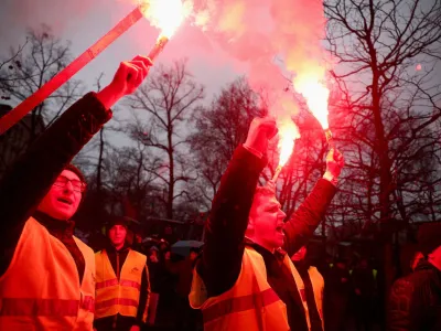 Demonstrators hold flares as Polish farmers protest over price pressures, taxes and green regulation, grievances shared by farmers across Europe, in Poznan, Poland, February 9, 2024. REUTERS/Kacper Pempel