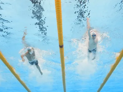 Vlad-Stefan Stancu of Romania, left, and David Aubry France, right, compete in the men's 400-meter freestyle heat at the World Aquatics Championships in Doha, Qatar, Sunday, Feb. 11, 2024. (AP Photo/Lee Jin-man)