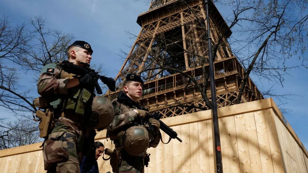 Armed French soldiers patrol at the Eiffel Tower as part of the "Vigipirate" security plan as France raises terror alert warning to the highest level, after the Moscow attack, in Paris, France, March 25, 2024. REUTERS/Benoit Tessier