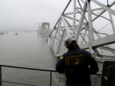 A National Transportation Safety Board (NTSB) worker looks on at the cargo vessel Dali, which struck and collapsed the Francis Scott Key Bridge, in Baltimore, Maryland, U.S. March 27, 2024. Peter Knudson/NTSB/Handout via REUTERS  THIS IMAGE HAS BEEN SUPPLIED BY A THIRD PARTY