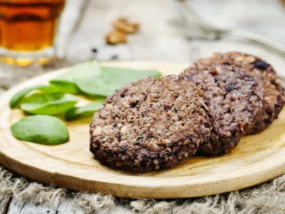 ﻿black beans brown rice walnut oat burgers with spinach. toning. selective focus