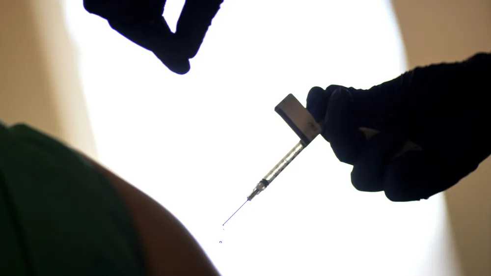 FILE - A droplet falls from a syringe after a health care worker was injected with the Pfizer-BioNTech COVID-19 vaccine at a hospital in Providence, R.I., Tuesday, Dec. 15, 2020. In 2023, many conspiracy theorists claimed a long-planned test of the emergency broadcast system would activate chemicals contained within COVID-19 vaccines. Those who got the shot would be killed, or perhaps turned into zombies. (AP Photo/David Goldman, File)