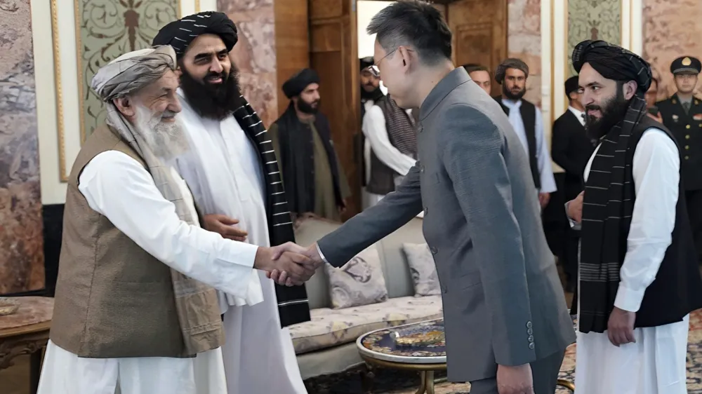 In this handout photo released by Taliban Prime Minister Media Office, China's new ambassador to Afghanistan Zhao Sheng shakes hand with Taliban Prime Minister Mohammad Hasan Akhund, left, during the recognition ceremony at the Presidential Palace, in Kabul, Afghanistan, Wednesday, Sept. 13, 2023. The Taliban on Wednesday greeted China's new ambassador to Afghanistan with pomp and ceremony, calling the envoy's nomination a significant step with a significant message. (Taliban Prime Minister Media Office via AP)