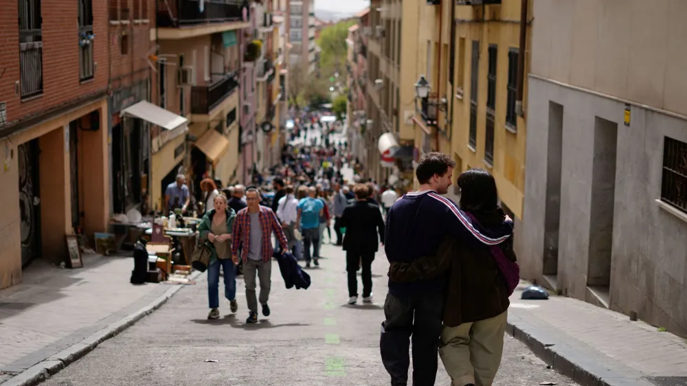 People walk through one of the streets of the Rastro open-air market in Madrid, Spain, April 7, 2024. REUTERS/Ana Beltran